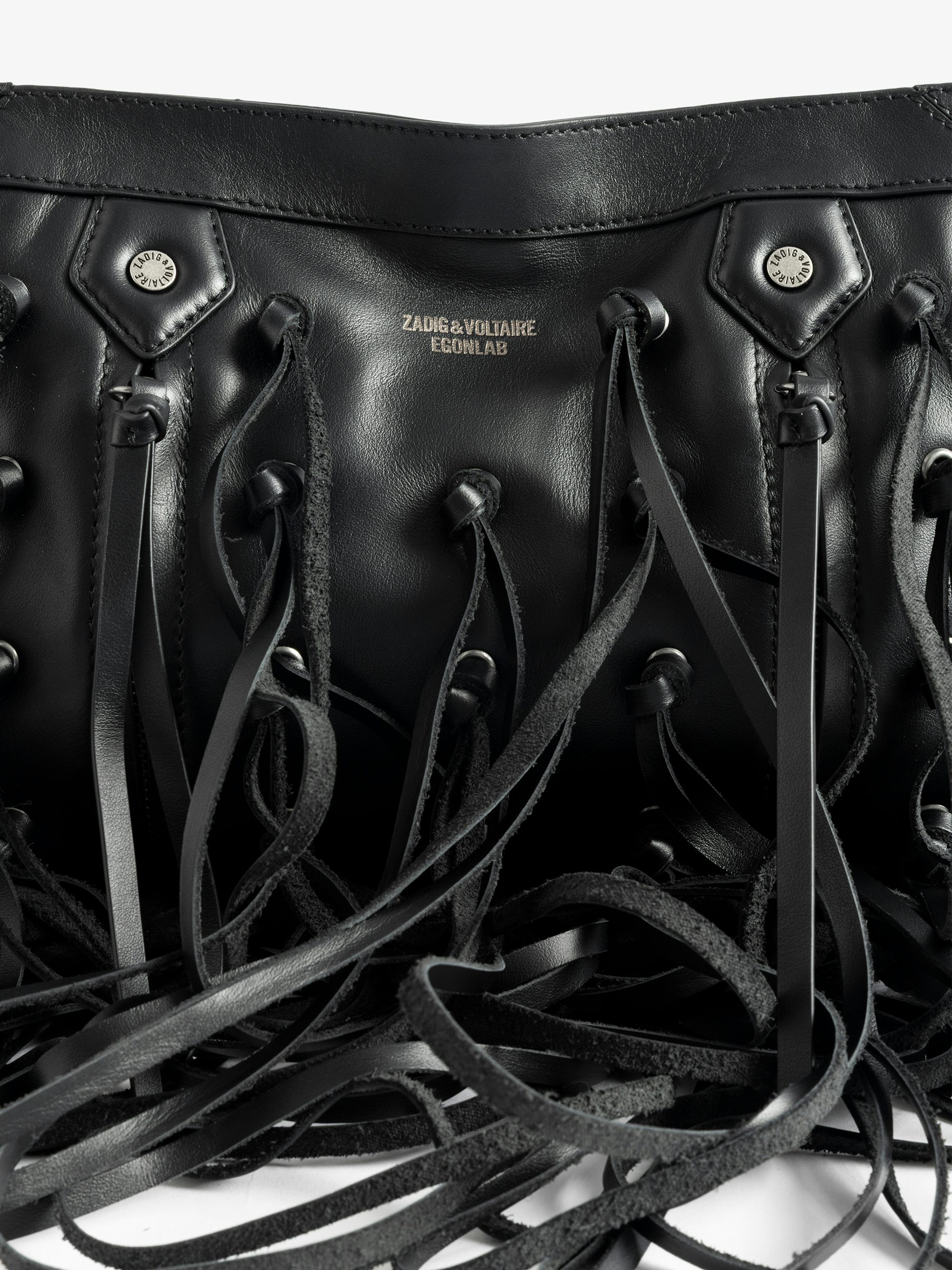 Sunny Moody Fringes Bag - A rebellion in motion. The Sunny Moody Fringes bag is reimagined with EGONlab’s signature edge—crafted in smooth black leather and slashed with dramatic fringe that moves with attitude. Western soul meets underground spirit in this bold, sculptural piece. Wear it slung over the shoulder or crossbody—just don’t expect to go unnoticed.